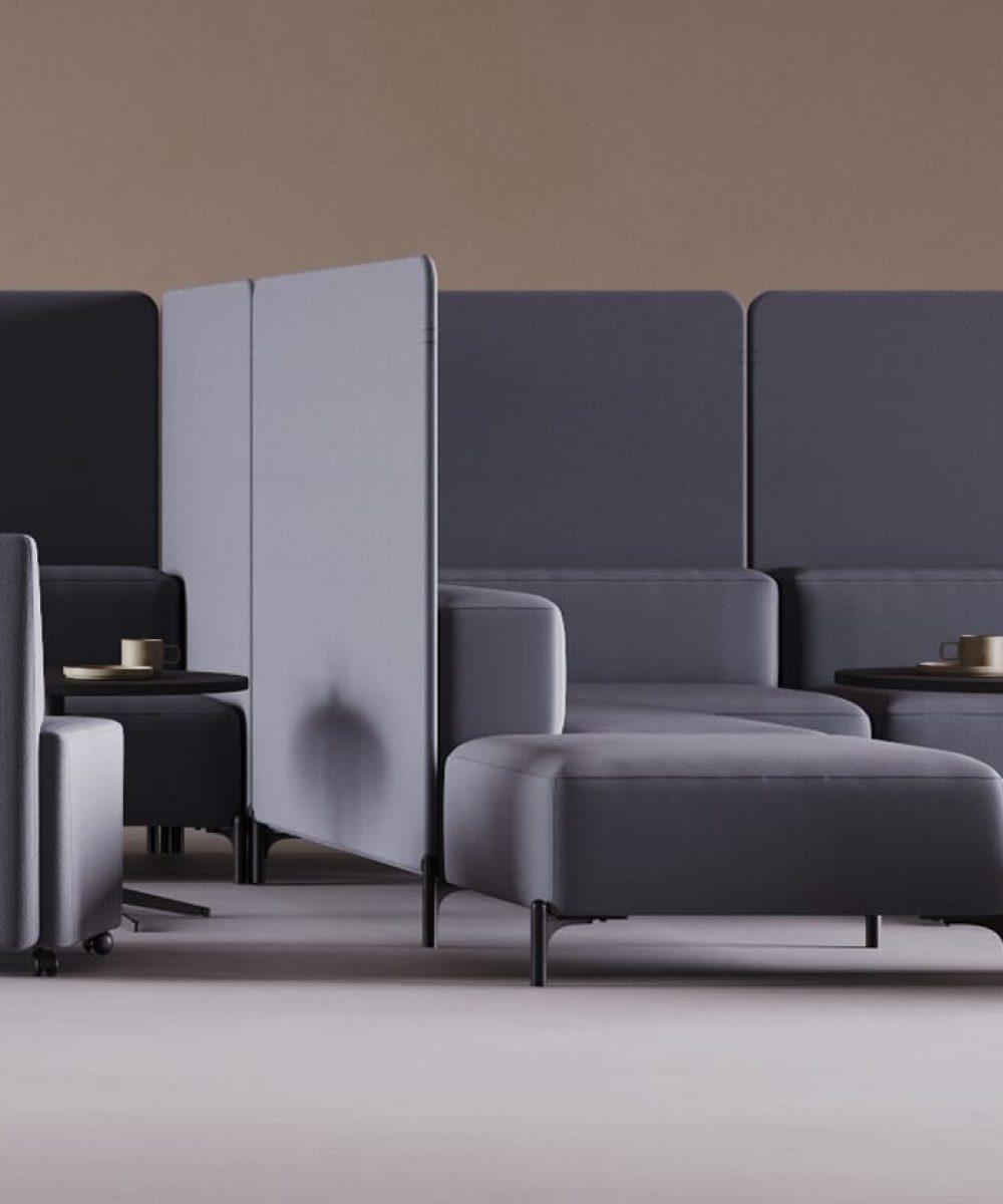 A blue office social space with office sofas, and office screen dividers