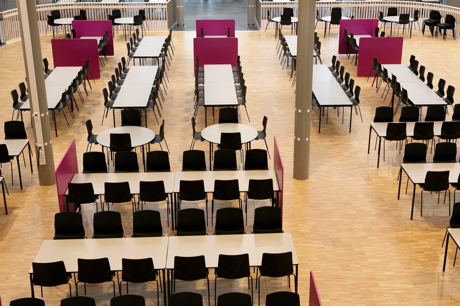 A large hall with office tables and chairs.