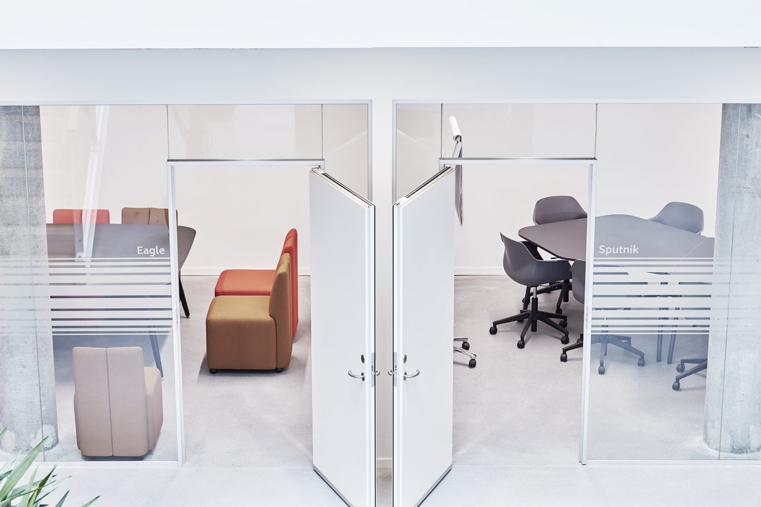 A glass door opens into a conference room.