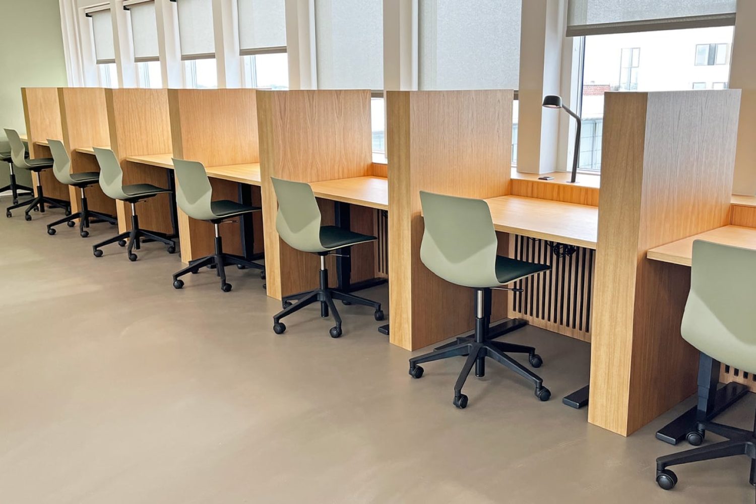 Study booths, desk workstations and chairs in a study hall