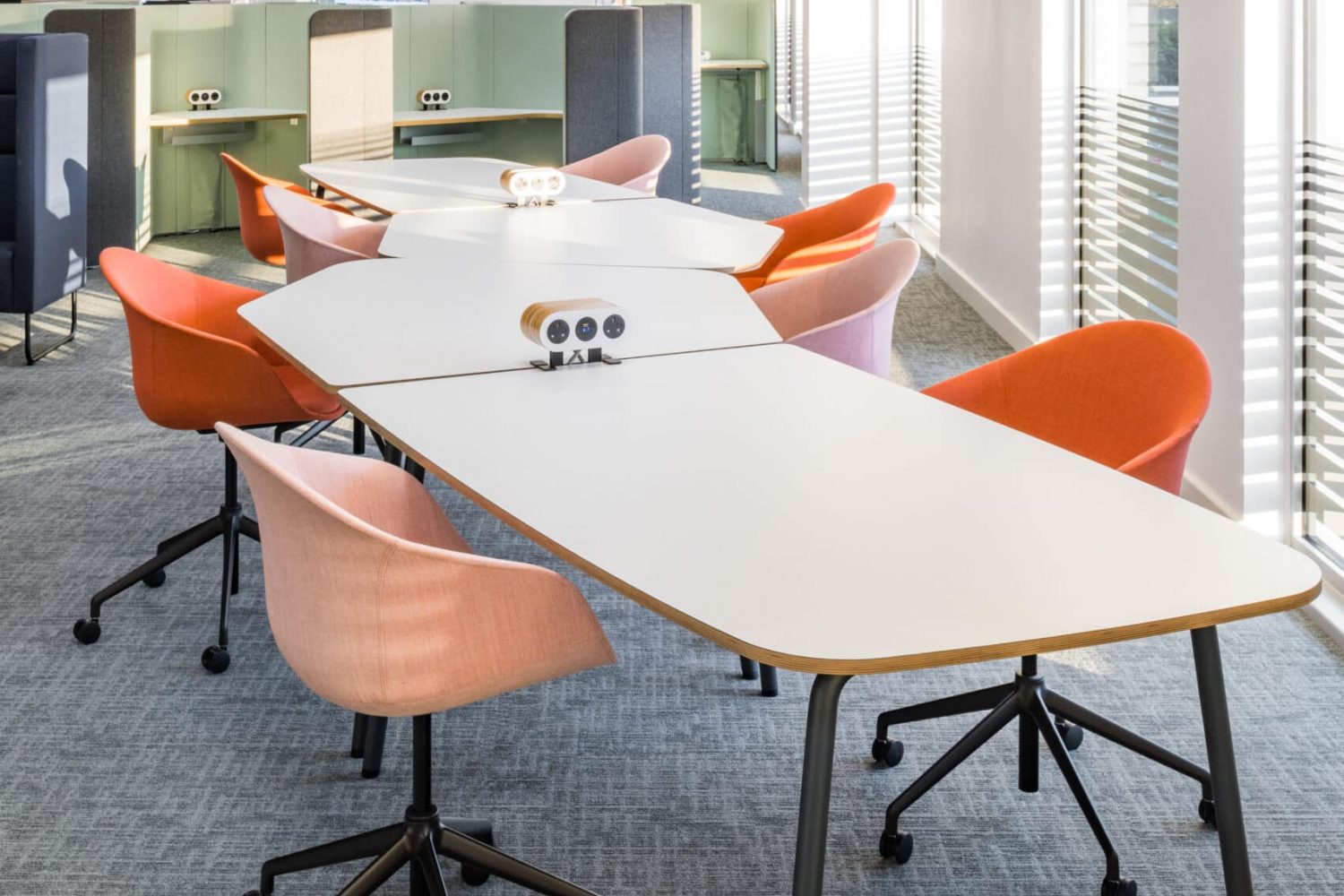 An office with Ocee and Four Design orange  desk chairs and a white table in Crawley Council Town Hall. 