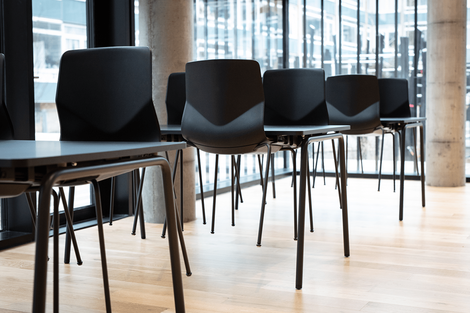 Canteen furniture including black table and chairs in a dining room.