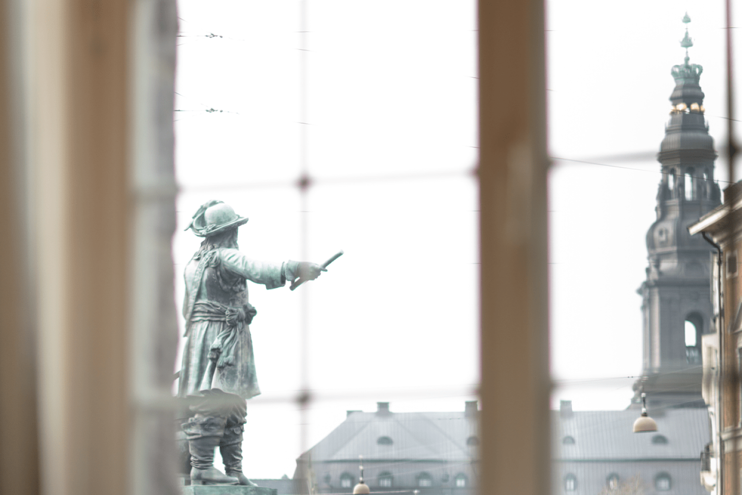 A statue of a soldier through a window.