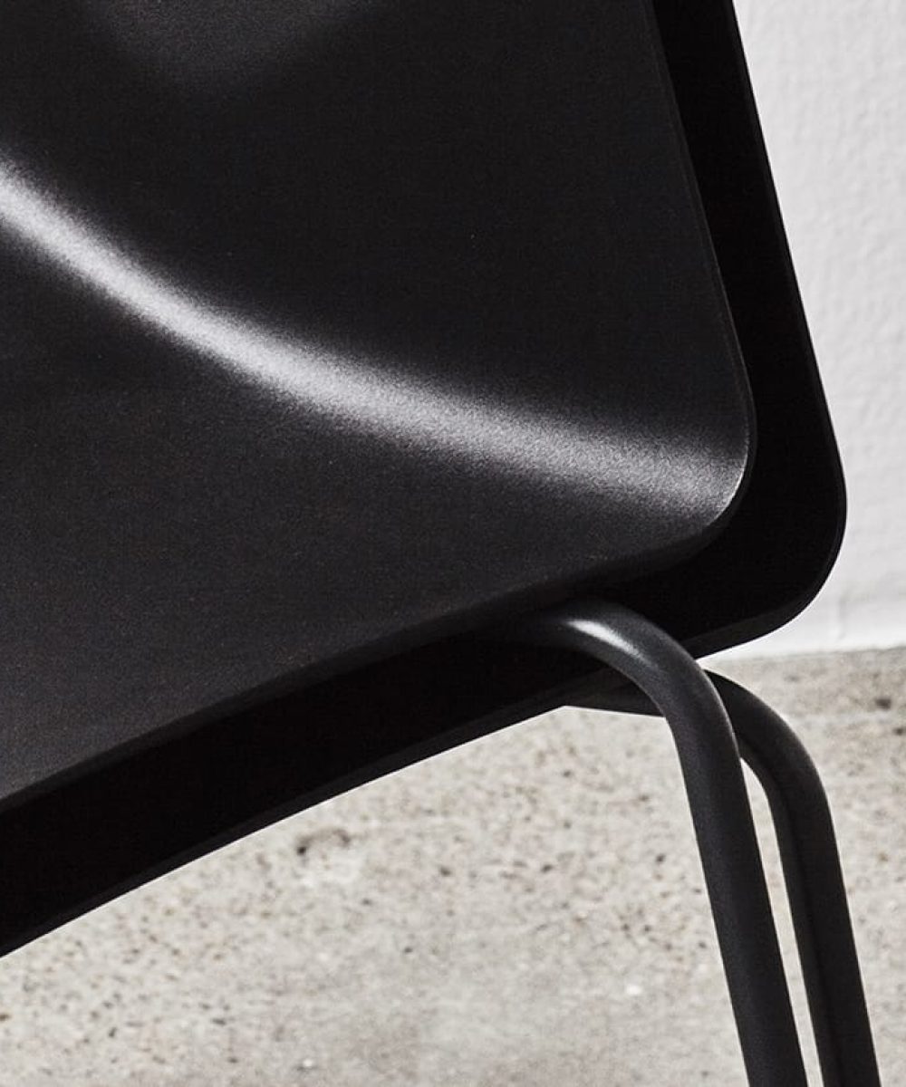 A close up of a black plastic chair.
