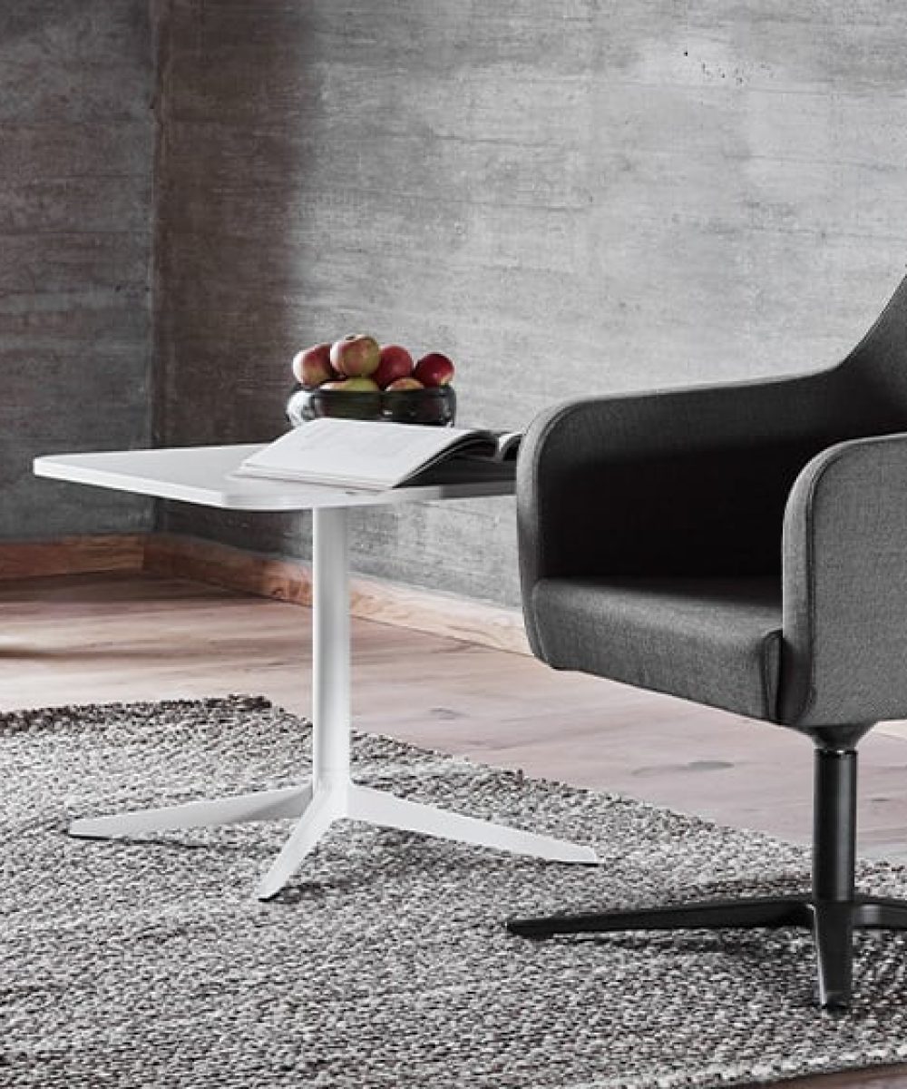 A modern chair and table in a room.