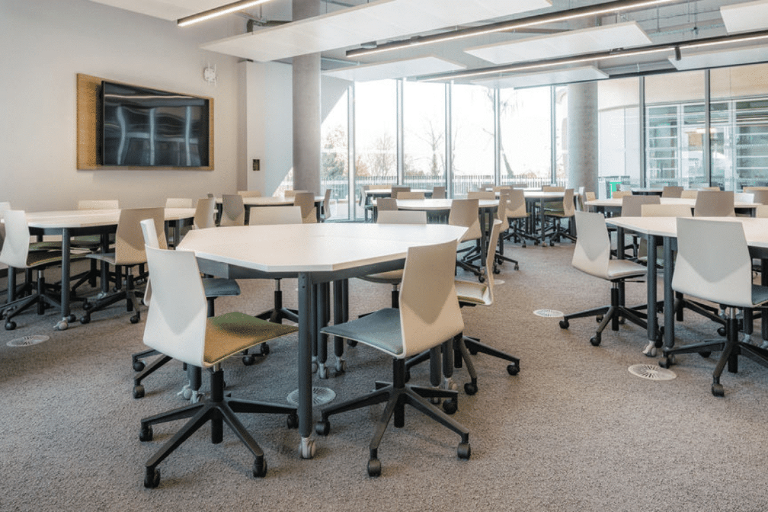 A large classroom with tables and chairs with Ocee and Four Design furniture showcasing our student centre design for the University of Sheffield